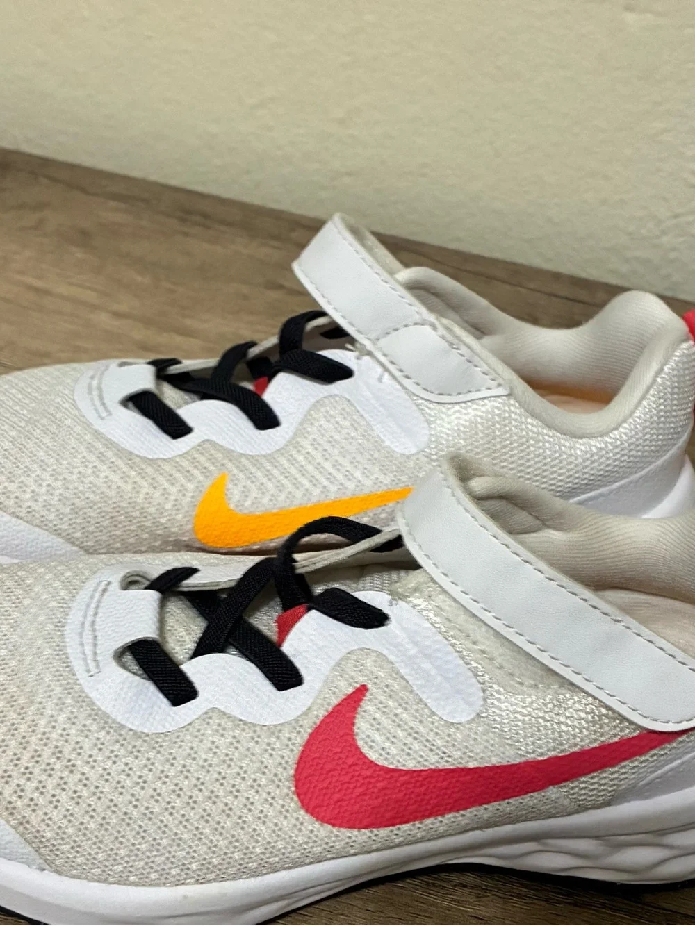 Girls Nike Kids White Sneakers with Pink Swoosh and Yellow Accent